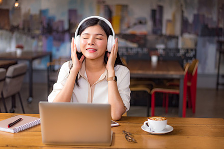 Beautiful Asian woman relaxing and listening to music in cafe wi, a Person Photo by Ministocker