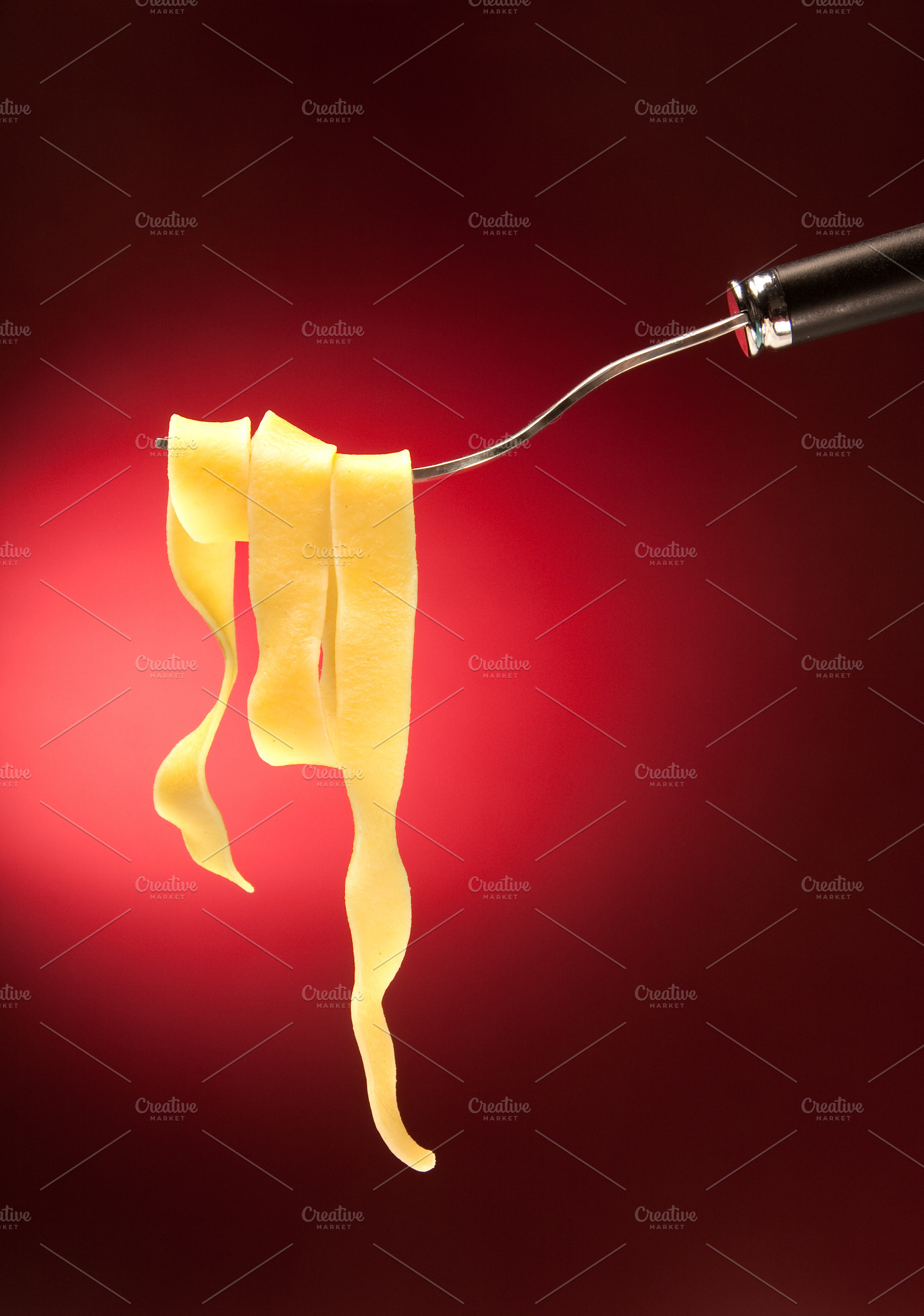 Fork with tagliatelle on a red background, a Food & Drink Photo by FoodStock