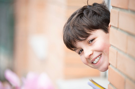 Cheerful teen boy smiling while looking to camera, a Person Photo by RF Images