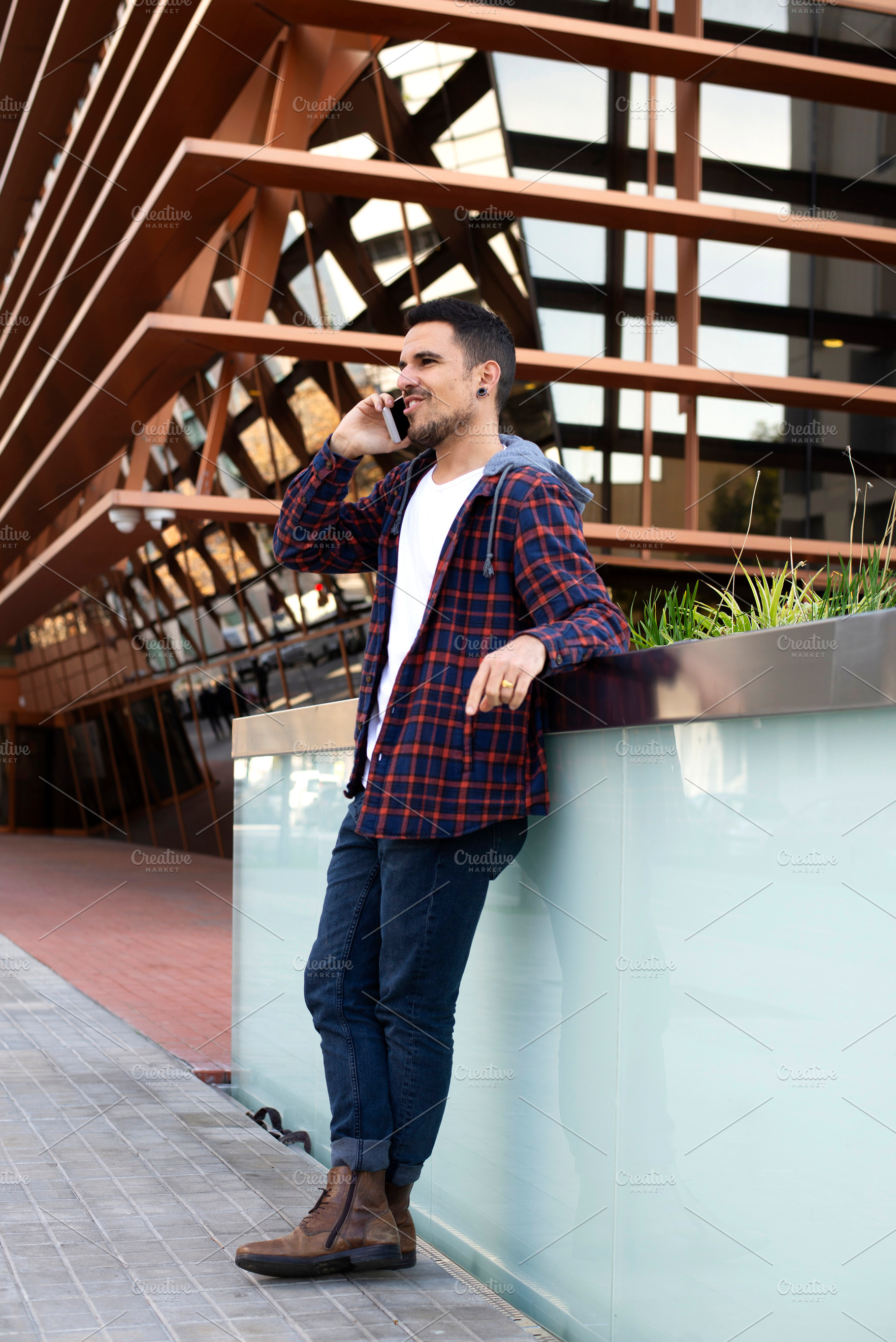 Caucasian man talking on smartphone near modern building, a Person Photo by RF Images