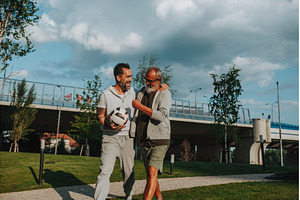 Sporty father and adult son walking, a Person Photo by HalfPoint
