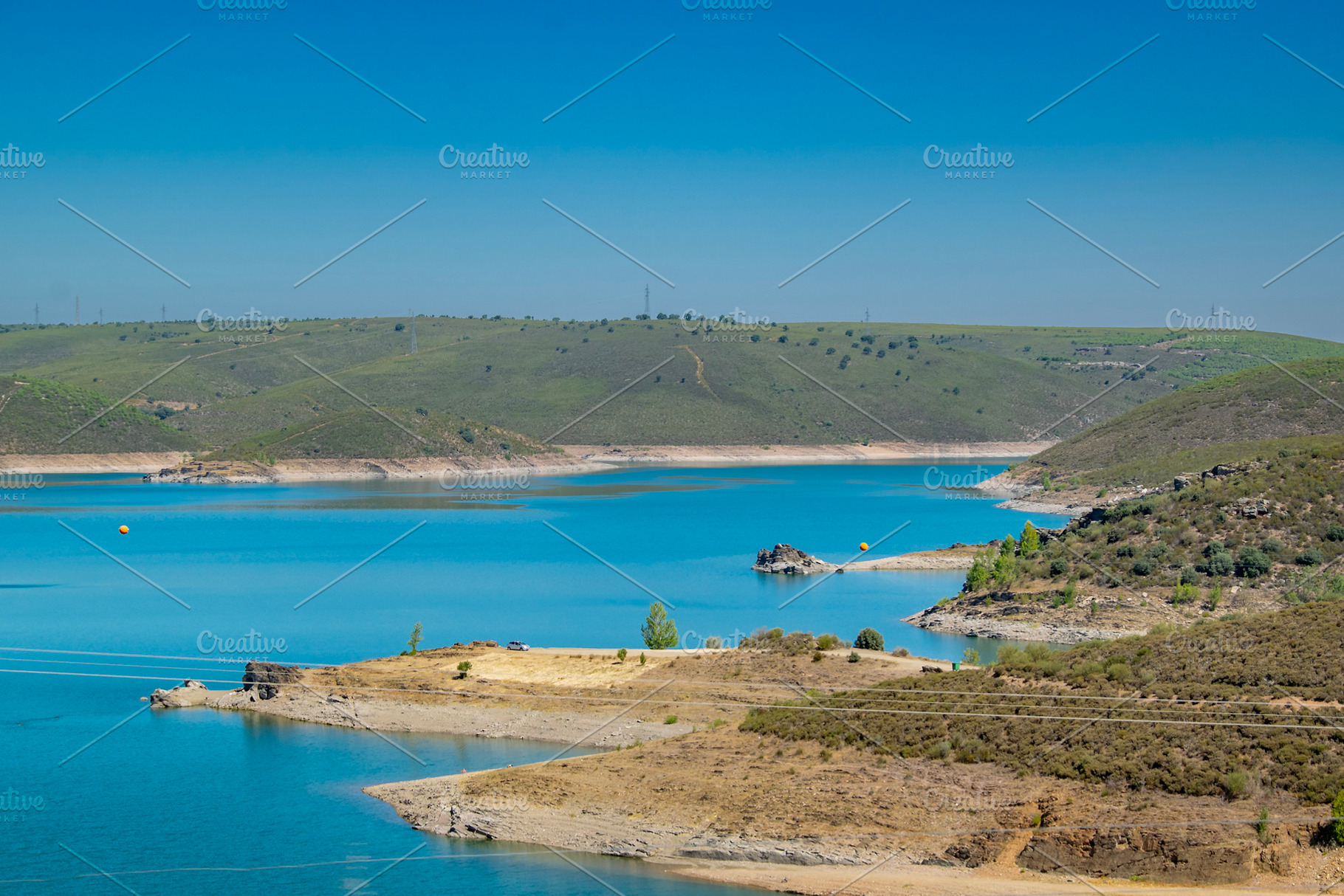 Lake surrounded by hills and arid landscape, a Nature Photo by DanFLCreativo