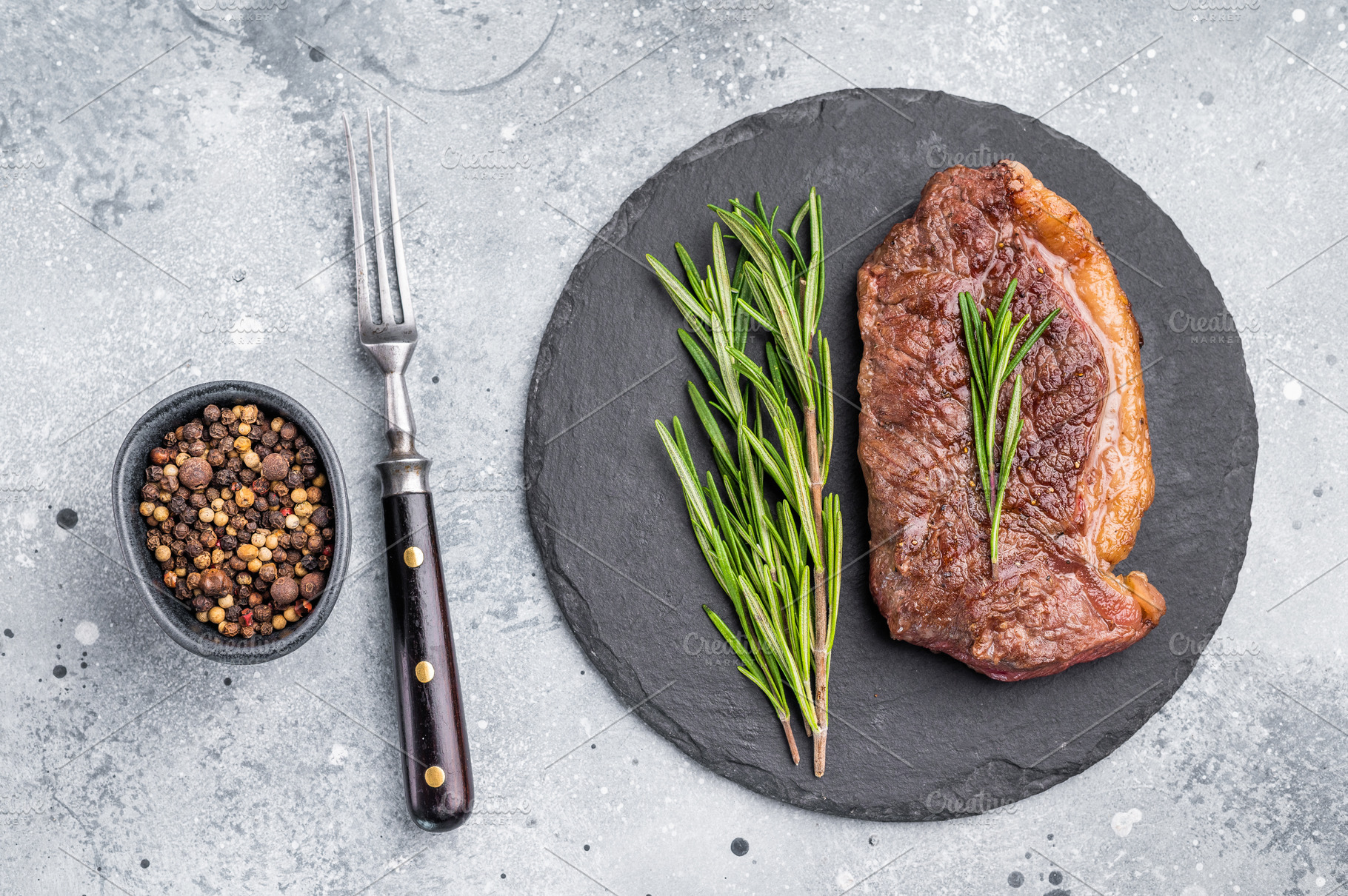 Close up of a flavorful grilled striploin or strip steak, garnis, a Food & Drink Photo by composter-box@mail.ru