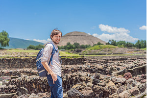 Male tourist posing in front of the, an Architecture Photo by Elizaveta Galitskaya