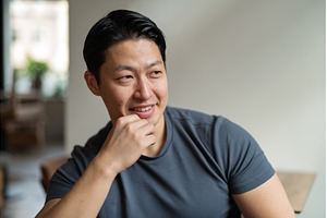 Athletic Asian man looking away in, a Person Photo by HalfPoint