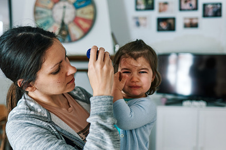 Mother with child crying in her arms at home, a Person Photo by YossSabalet