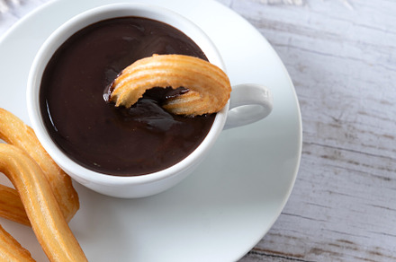 Traditional Spanish churros with hot chocolate breakfast on wood, a Food & Drink Photo by etorres69