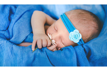 Newborn baby sleeping on a blue, a Person Photo by yanadjana