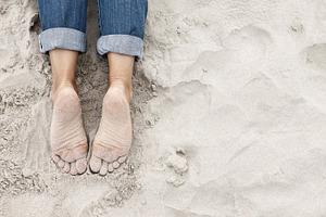 Sandy young woman feet on the beach, a Person Photo by BOOCYS