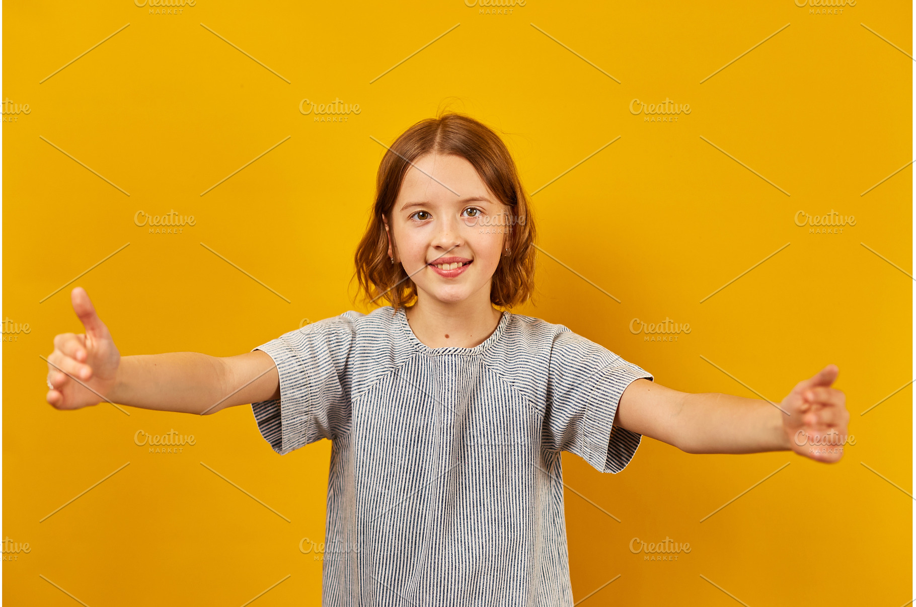 Cheerful girl giving thumbs up with, a Background Photo by IlliaBondarPhotography