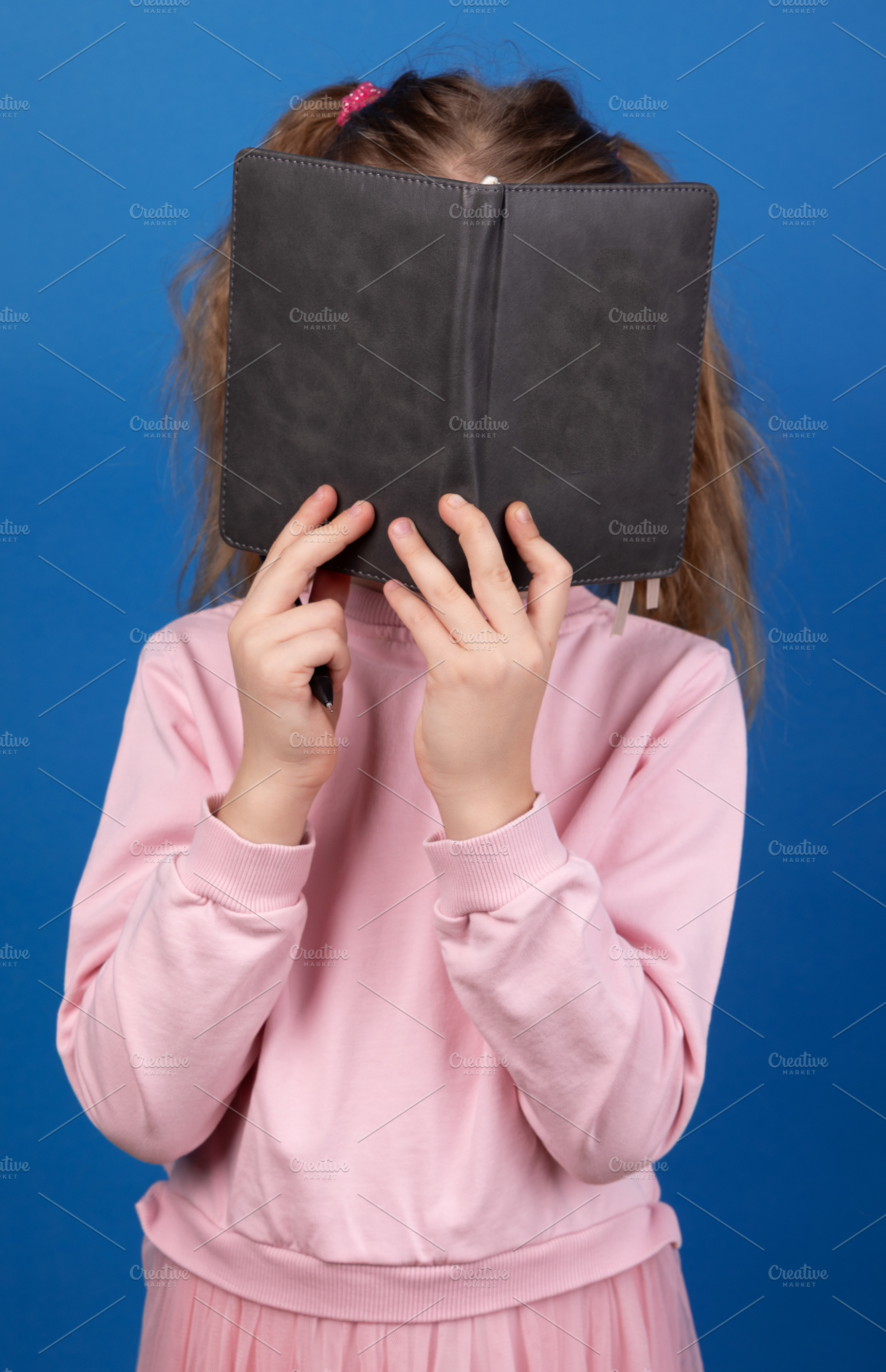 Child Reading Book on Blue Background, a Person Photo by Ales Munt