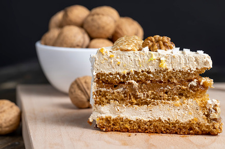 a piece of cake with buttercream and walnuts, a Food & Drink Photo by MyPhotos
