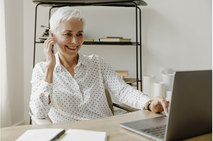 Smiling stylish mature woman sitting