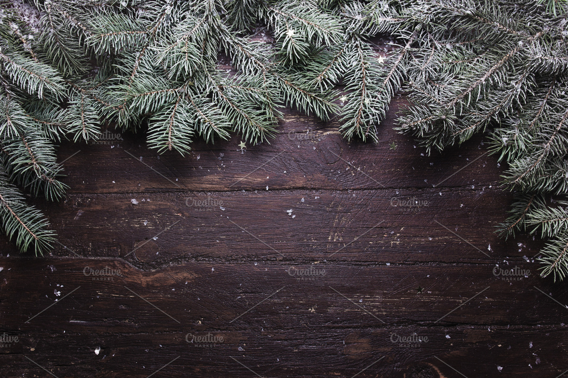 Christmas and New Year decoration composition. Top view of fur-tree branches on wooden background with place for your text, a Background Photo by Maksimkostenko