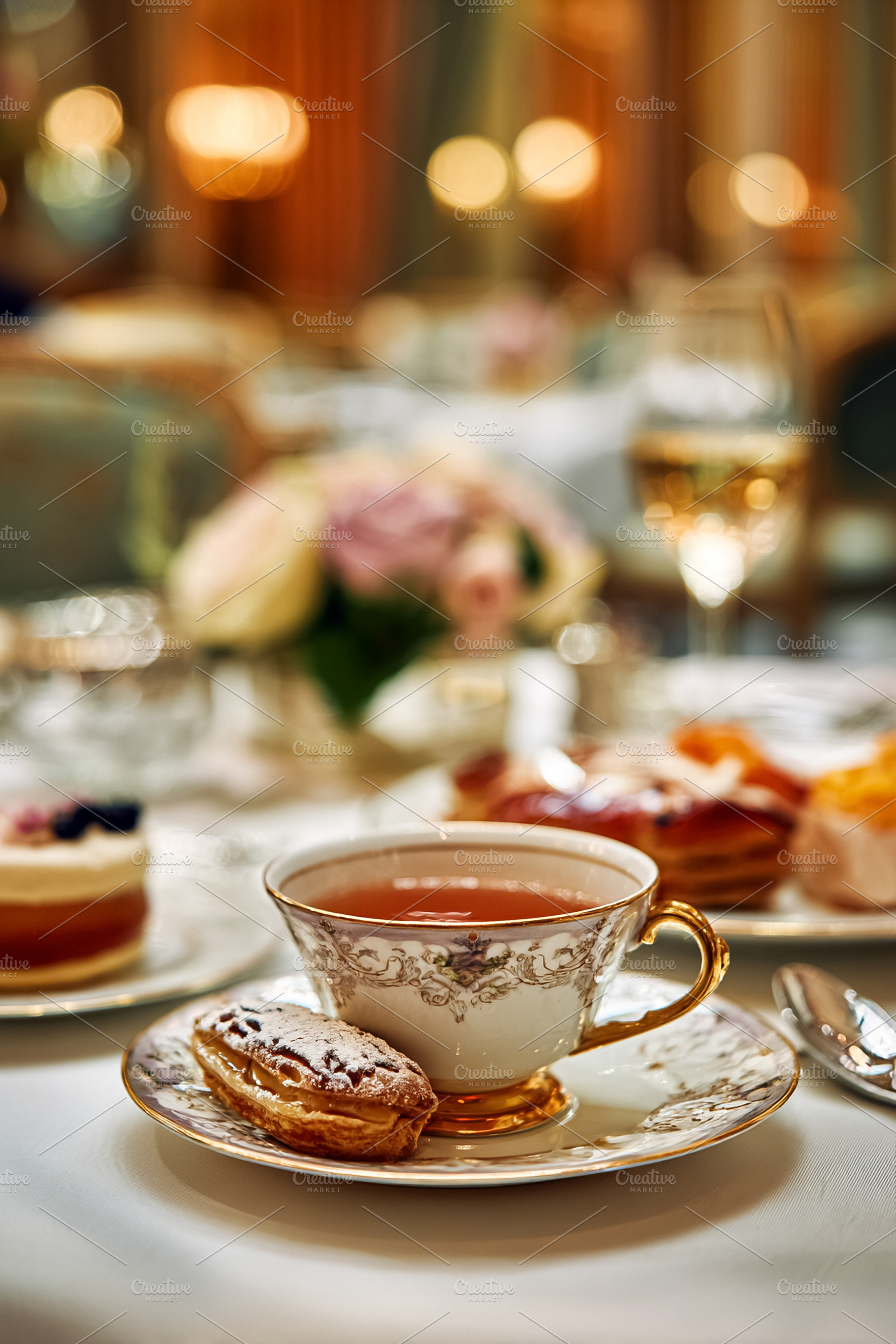 Elegant tea cup and pastry on a table setting, enjoying high tea, a Food & Drink Photo by Studio ANNA