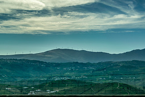 Hills under streaked sky with turbines, a Nature Photo by DanFLCreativo