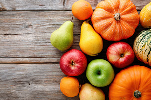Fresh autumn fruits and vegetables on wooden table, a Food & Drink Photo by AlyaAnd