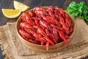 Wooden bowl of bright red boiled cra, a Food & Drink Photo by Alexander Prokopenko