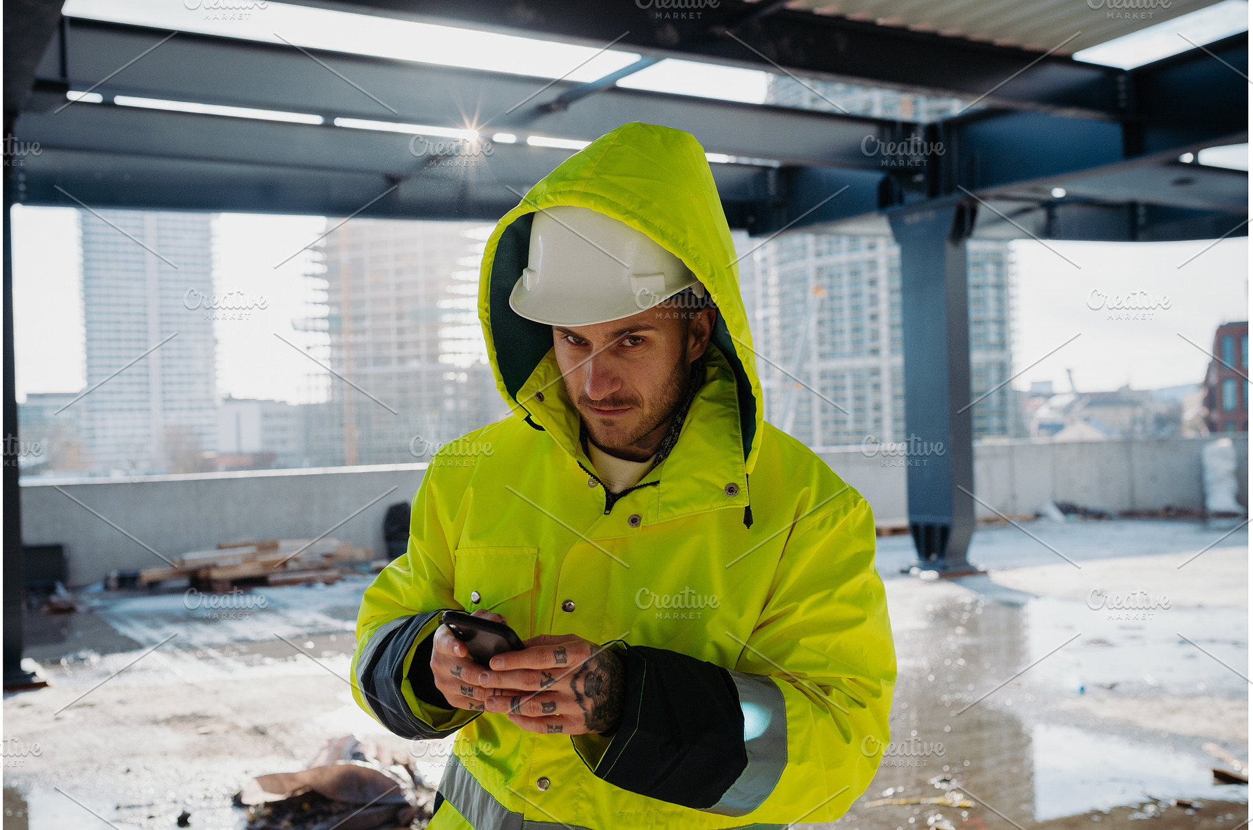 Construction worker text messaging, an Industrial Photo by HalfPoint