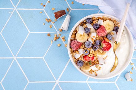 Breakfast yogurt granola bowl with fruit and berry, a Food & Drink Photo by Rimma
