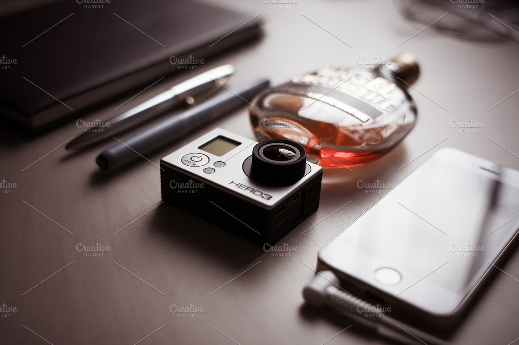 Gopro & other equipment containing desk, gopro, and camera
