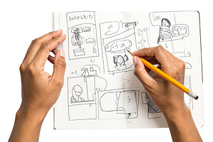 Persons hands drawing a storyboard in a notebook, an Arts & Entertainment Photo by DanFLCreativo