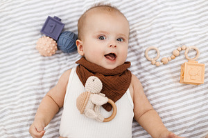 Beautiful happy baby lying on blanket with toys and teether in s, a Person Photo by Sonjachni