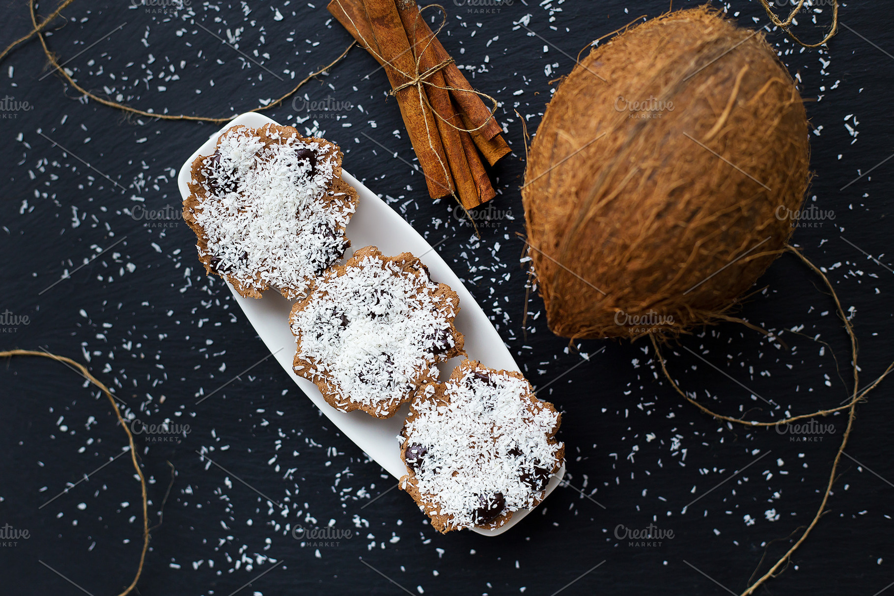 coconut muffins on a black background, a Food & Drink Photo by Artsaba Family