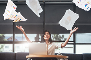 Asian beauty businesswoman throwing paperwork into the air. Succ