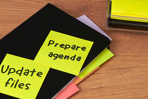sticky notes on a notebook for daily task planning, a Photo by Nito
