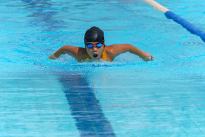 Swimmer child swims butterfly swimming style in a race swimming, a Sports & Recreation Photo by Casanowe-studio