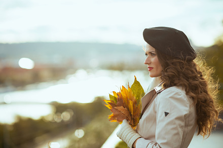 pensive stylish woman in beige trench coat, a Person Photo by Alliance Images