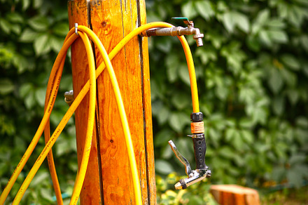 water outlet well with hose in green