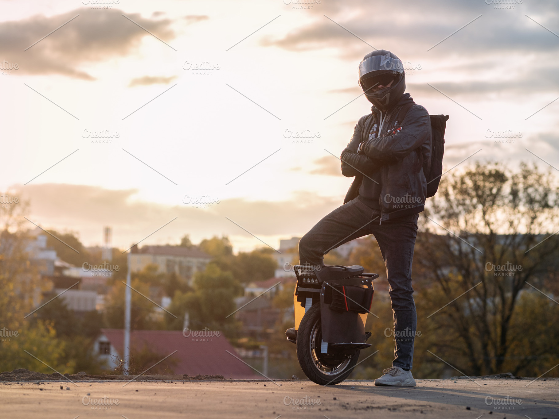 A young male rider in protective gear with a backpack on an electric unicycle a, a Person Photo by PavelKant