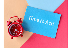 Red alarm clock and blue card with, a Photo by tilialucida