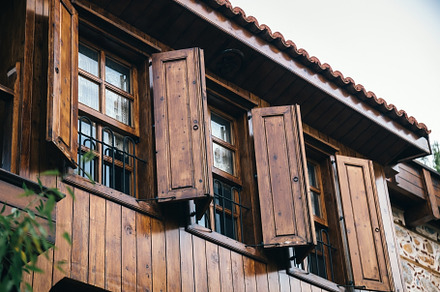 open wooden shutters on wooden windows in a Turkish house., an Architecture Photo by TanaCh
