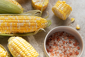 Fresh sweet corn cobs with salt on table, a Food & Drink Photo by Olena Rudo
