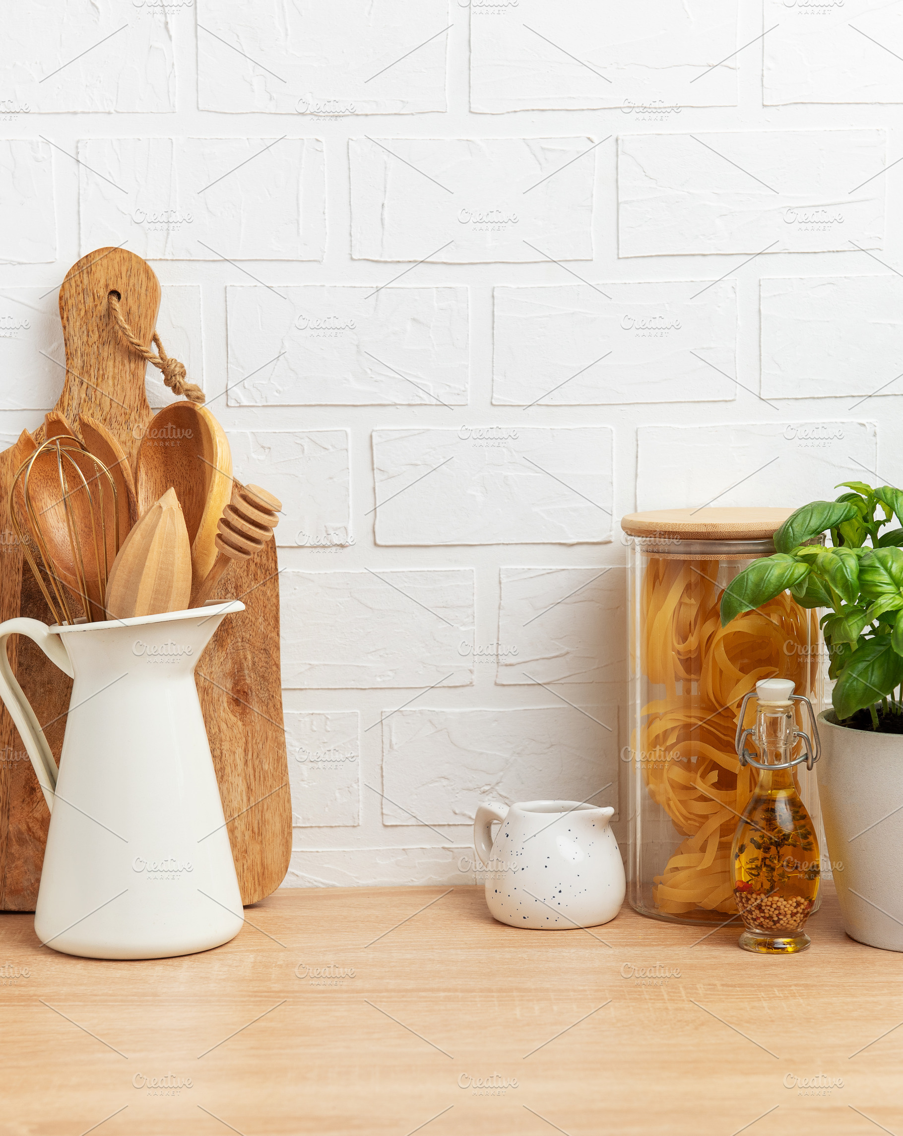 Kitchen utensils, pasta and basil showing rustic cooking and hea, a Photo by Olena Rudo