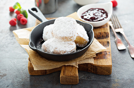 Beignets with powdered sugar, a Background Photo by farwasser
