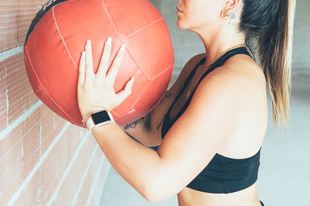 Concentrated fit woman doing wall ball routine, a Sports & Recreation Photo by Click and Photo