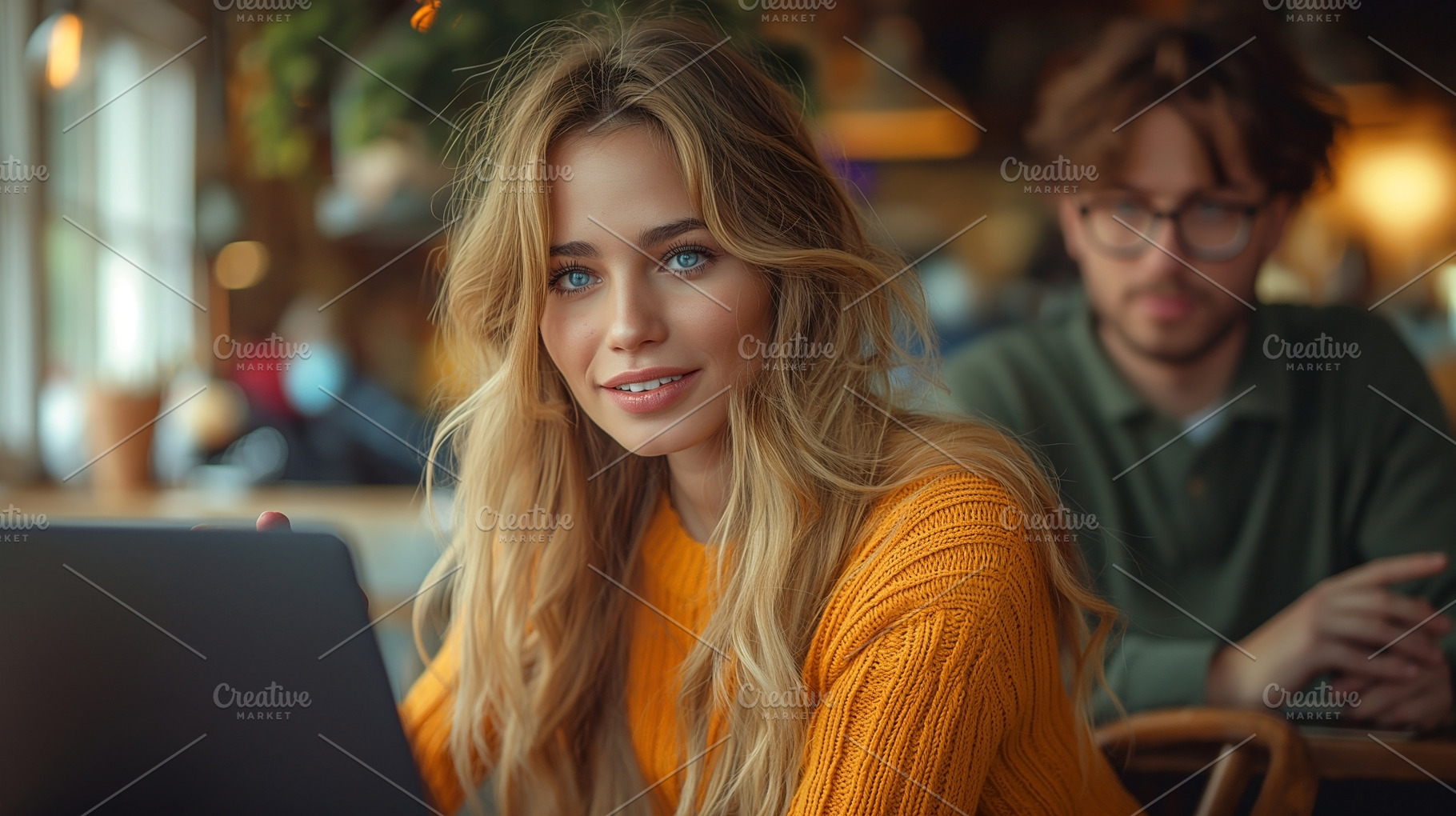 A young Caucasian woman with long hair smiles while working on her laptop in a, a Person Photo by ImageMir