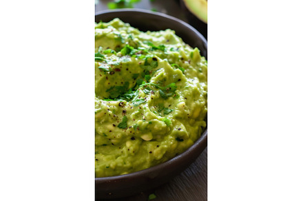 Guacamole dip in bowl garnished with, a Food & Drink Photo by Lermont51