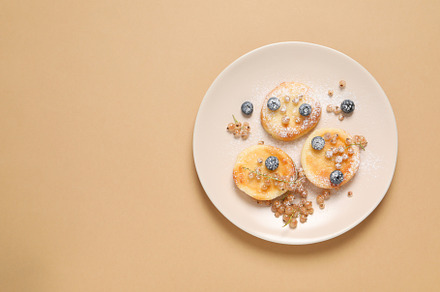 Concept of tasty sweet food, cheese pancakes, space for text, a Food & Drink Photo by AtlasStudio PRO