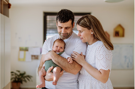 Happy parents cuddling with their, a Person Photo by HalfPoint