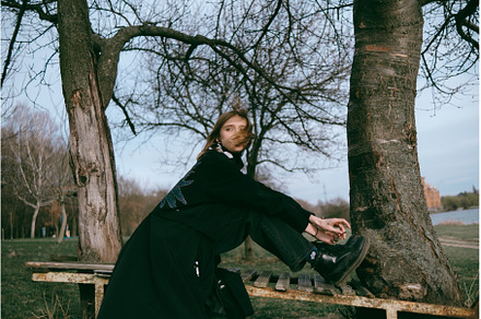 the lioness sits in a park on a, a Person Photo by zheckasmk