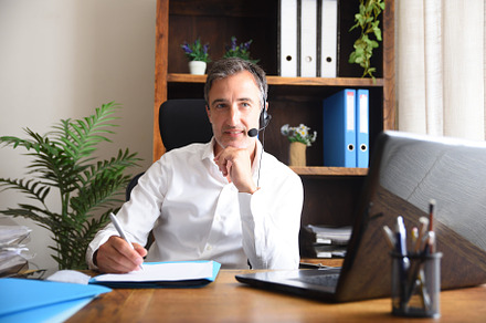 Man working virtually taking notes in online meeting, a Business Photo by Davizro's Market