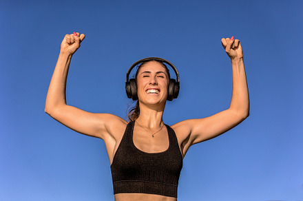 Woman raising arms in triumph, a Sports & Recreation Photo by Perpis