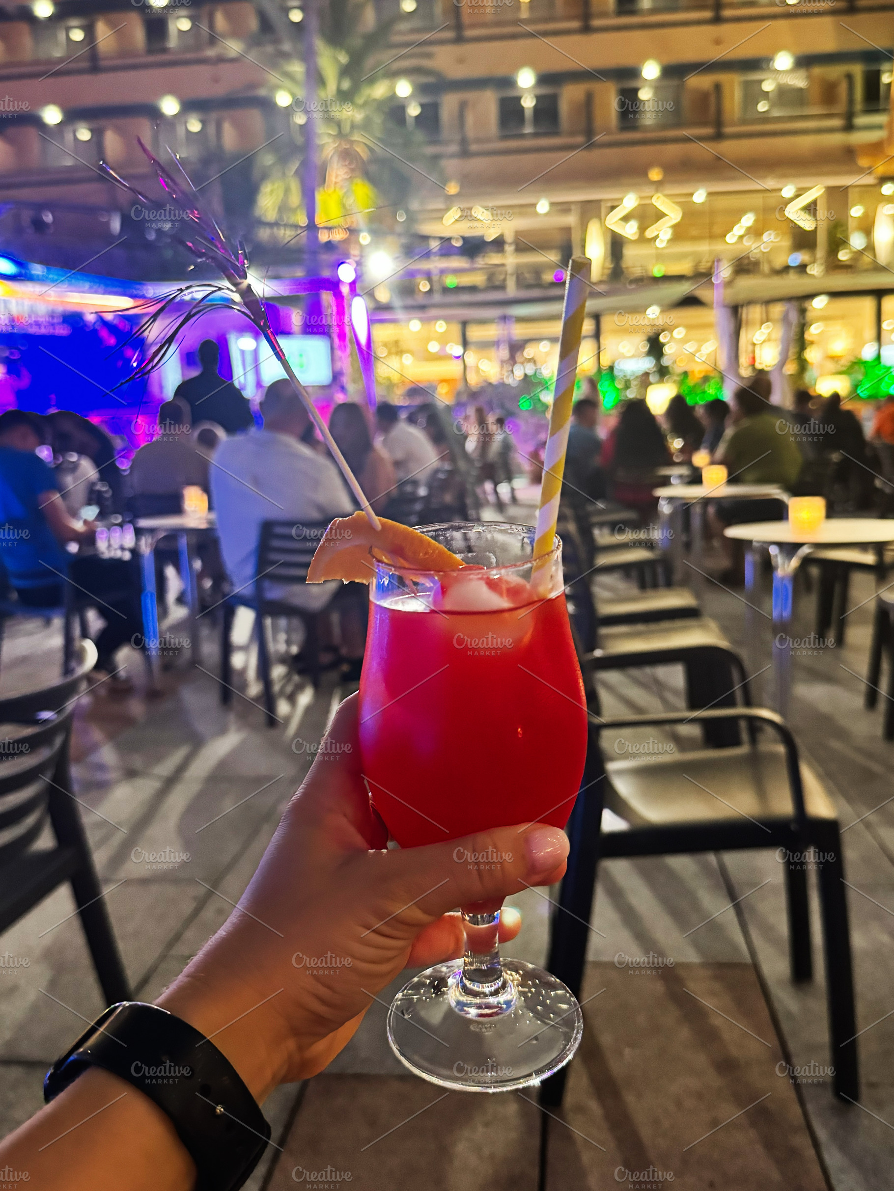 Vibrant cocktail evening at an outdoor restaurant in Cancun, Mexico with music, a Photo by AS photostudio