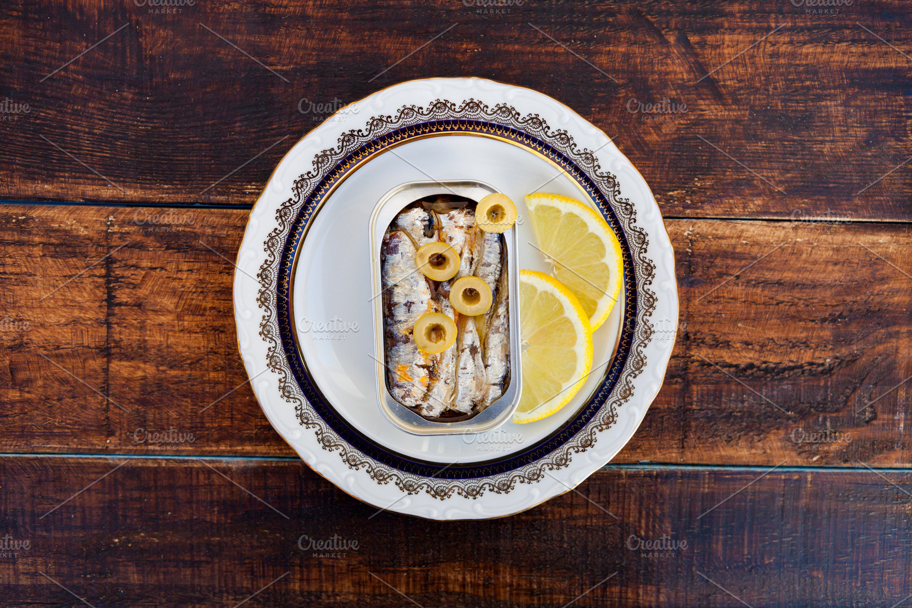 Can of canned oil sardines on a elegant plate, a Food & Drink Photo by José Manuel Gelpi