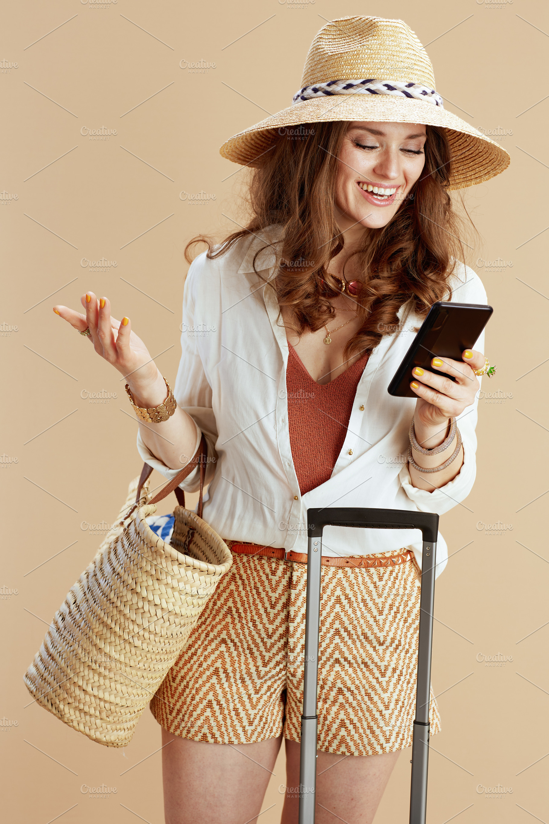smiling trendy housewife in blouse and shorts isolated on beige, a Person Photo by Alliance Images